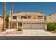 Inviting two-story home featuring a three-car garage, a balcony, and well-maintained landscaping at 9604 Summer Cypress St, Las Vegas, NV 89123