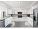 Bright kitchen features white cabinets, granite countertops, stainless steel appliances, and a center island at 9604 Summer Cypress St, Las Vegas, NV 89123