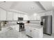 Bright kitchen features white cabinets, granite countertops, and stainless steel appliances for a modern space at 9604 Summer Cypress St, Las Vegas, NV 89123