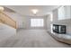 Open-concept living room boasts a modern fireplace, staircase, and ample natural light for a welcoming space at 9604 Summer Cypress St, Las Vegas, NV 89123