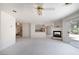 Spacious living room featuring a fireplace, ceiling fan, and sliding door access to the backyard at 9604 Summer Cypress St, Las Vegas, NV 89123