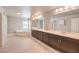 Bright and spacious bathroom featuring a soaking tub, double vanity, and tile floors at 9876 Parador Cellars Ct, Las Vegas, NV 89141
