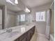 Bathroom with a long counter and large mirror at 9876 Parador Cellars Ct, Las Vegas, NV 89141
