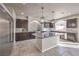 Modern kitchen with granite island, pendant lighting, stainless appliances, and tile backsplash at 9876 Parador Cellars Ct, Las Vegas, NV 89141