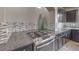 Close-up on gas cooktop with granite countertops, mosaic tile backsplash, and dark cabinets at 9876 Parador Cellars Ct, Las Vegas, NV 89141