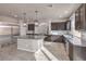 Bright kitchen features stainless appliances, granite island, and dark wood cabinetry at 9876 Parador Cellars Ct, Las Vegas, NV 89141