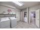 Spacious laundry room with washer, dryer, sink, and overhead storage at 9876 Parador Cellars Ct, Las Vegas, NV 89141