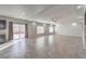 Open living space with tile flooring, recessed lights, ceiling fans, and sliding door to the backyard at 9876 Parador Cellars Ct, Las Vegas, NV 89141