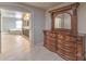 Spacious main bedroom with a large dresser and an en-suite bathroom with a soaking tub at 9876 Parador Cellars Ct, Las Vegas, NV 89141