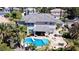 Aerial view of a home featuring a private pool with spa and lush tropical landscaping, creating a backyard oasis at 9905 Fox Springs Dr, Las Vegas, NV 89117
