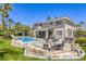 Spacious backyard with a pool, spa, outdoor kitchen, and patio, ideal for outdoor living and entertaining at 9905 Fox Springs Dr, Las Vegas, NV 89117