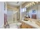 Bright bathroom with a large mirror, and a shower with a glass door at 9905 Fox Springs Dr, Las Vegas, NV 89117