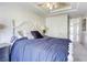 Comfortable bedroom featuring a decorative ceiling fan, stylish bedding, and neutral wall colors at 9905 Fox Springs Dr, Las Vegas, NV 89117