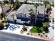 A luxurious home featuring mature palm trees, a well-manicured lawn, and a convenient three-car garage and long driveway at 9905 Fox Springs Dr, Las Vegas, NV 89117