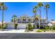 Stunning two-story home featuring a three-car garage, mature landscaping, and tall palm trees in a sunny neighborhood at 9905 Fox Springs Dr, Las Vegas, NV 89117