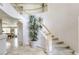 Elegant foyer showcasing an open staircase, marble flooring, and views into adjacent living spaces, highlighting architectural detail at 9905 Fox Springs Dr, Las Vegas, NV 89117