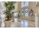 Grand foyer featuring marble floors, a decorative medallion, and an elegant staircase, creating a welcoming first impression at 9905 Fox Springs Dr, Las Vegas, NV 89117