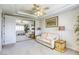 Bright living room with tray ceilings, a large mirrored closet, and a beige sofa at 9905 Fox Springs Dr, Las Vegas, NV 89117