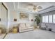 Cozy living room features a neutral color palette, tray ceiling, and a comfortable sofa at 9905 Fox Springs Dr, Las Vegas, NV 89117
