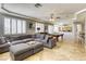 Open living room with a comfortable gray sectional sofa, pool table, and a view into the kitchen at 9905 Fox Springs Dr, Las Vegas, NV 89117