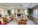 Cozy living room with a fireplace, plush seating, and natural light from large windows, creating a relaxing atmosphere at 9905 Fox Springs Dr, Las Vegas, NV 89117