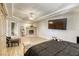 Well-lit main bedroom showcases tray ceilings, a fireplace, and modern finishes at 9905 Fox Springs Dr, Las Vegas, NV 89117