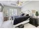 Comfortable main bedroom featuring neutral walls, dark furniture, and natural light at 9905 Fox Springs Dr, Las Vegas, NV 89117