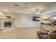 Open main bedroom features a modern fireplace, tray ceilings, and wood-look floors at 9905 Fox Springs Dr, Las Vegas, NV 89117