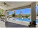 Inviting backyard features a sparkling pool and spa with rock waterfall, set amidst lush landscaping and a covered patio at 9905 Fox Springs Dr, Las Vegas, NV 89117