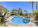 Beautiful backyard pool and spa with rock waterfall feature, perfect for relaxation and entertaining at 9905 Fox Springs Dr, Las Vegas, NV 89117