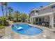 Gorgeous backyard with a sparkling pool, spa, and lush landscaping, all complemented by the home's exterior at 9905 Fox Springs Dr, Las Vegas, NV 89117