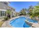 Large backyard with pool, spa, covered patio, and lush landscaping, creating a private oasis for outdoor living at 9905 Fox Springs Dr, Las Vegas, NV 89117