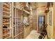 Custom wine cellar featuring ample storage, custom lighting, and a wine refrigerator for optimal preservation at 9905 Fox Springs Dr, Las Vegas, NV 89117