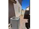 A view of the side yard with an AC unit and gravel at 9940 Trailing Vine St, Las Vegas, NV 89183
