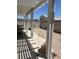 View of backyard with empty lot and covered patio with large backyard, perfect for outdoor entertaining at 9940 Trailing Vine St, Las Vegas, NV 89183