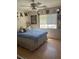 Bedroom with hardwood floors, ceiling fan and decorated with mirrors at 9940 Trailing Vine St, Las Vegas, NV 89183