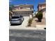 Exterior shot of the home with a two-car garage and neutral color scheme at 9940 Trailing Vine St, Las Vegas, NV 89183