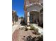 Inviting front entrance with covered porch, decorative accents, and a neatly landscaped garden area at 9940 Trailing Vine St, Las Vegas, NV 89183