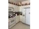 A kitchen with white appliances and upper cabinet decor at 9940 Trailing Vine St, Las Vegas, NV 89183