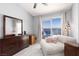 Bright bedroom featuring a dresser, stylish chaise lounge, and patio access at 998 Hunters Run Dr, Henderson, NV 89002