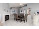 Inviting dining area featuring tile floors, modern fireplace, and built-in shelving for stylish storage and decor at 998 Hunters Run Dr, Henderson, NV 89002