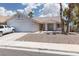 Charming single-story home with desert landscaping, tiled roof, and a two-car garage at 998 Hunters Run Dr, Henderson, NV 89002