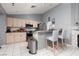 Functional kitchen boasting stainless steel appliances, bar seating, and bright recessed lighting for a modern touch at 998 Hunters Run Dr, Henderson, NV 89002