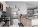 Well-equipped kitchen features stainless steel appliances and double sink, with open layout into the living spaces at 998 Hunters Run Dr, Henderson, NV 89002