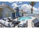 Inviting backyard with sparkling pool, patio furniture, and grill, perfect for outdoor entertaining at 998 Hunters Run Dr, Henderson, NV 89002