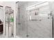 Modern shower with glass enclosure, stylish tile, and built-in shelving at 998 Hunters Run Dr, Henderson, NV 89002