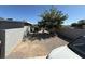 View of a spacious backyard featuring desert landscaping, a mature tree, and a privacy fence at , Las Vegas, NV 89104