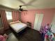 Cozy bedroom featuring modern ceiling fan, pink walls and a comfortable bed at , Las Vegas, NV 89104