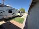 RV parked in a side yard featuring synthetic turf, concrete blocks, and a privacy fence at , Las Vegas, NV 89104