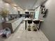 Modern kitchen featuring white cabinets, gray countertops, stainless steel appliances, and a breakfast bar at , Las Vegas, NV 89104